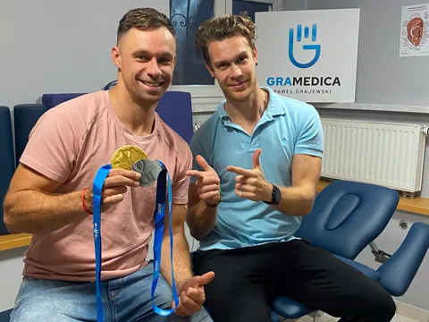 Paweł Grajewski ze sportowcem z medalem